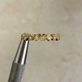 Salisbury Band held in prongs within square and diamonds