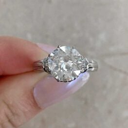 trun engagement ring with single cut diamonds set across the curved shoulders