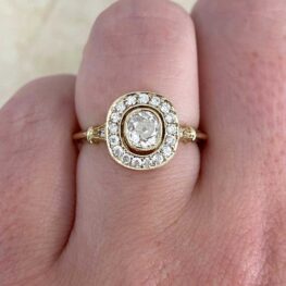 Faro Ring exhibiting a 0.60 carat antique cushion cut diamond