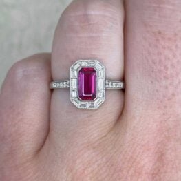 Tirana Ring features an 1.25 carat emerald-cut elongated ruby center