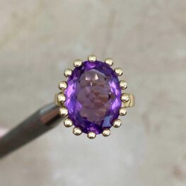 Tresta Ring with center stone surrounded by a halo of gold bead-shaped prongs