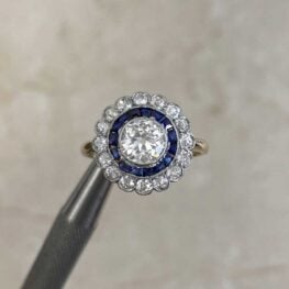 Macon Ring with a row of French-cut calibre natural sapphires surrounding the center stone